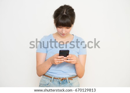 Young woman looking into the phone