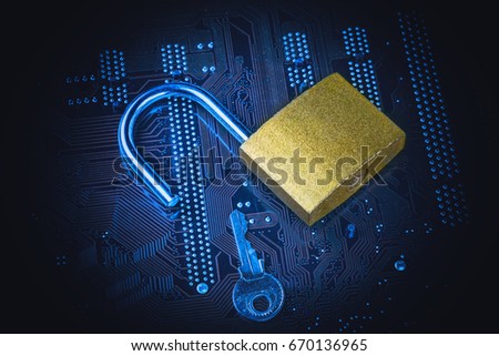 Opened padlock with a key on computer motherboard. Internet data privacy information security concept. Blue toned image