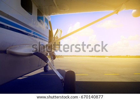 plane  stay on  runway with the open door. island of Zanzibar.