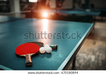Ping pong table, rackets and balls in a sport hall Royalty-Free Stock Photo #670180894
