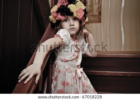 Picture of a funny little girl playing top model