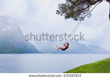 romantic girl on the swing, sweet dreams, daydream concept background Royalty-Free Stock Photo #670185814