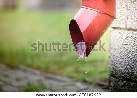 Rainwater flows out of the drainpipe