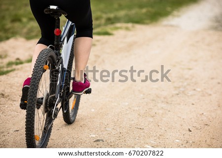 Middle-aged woman riding bicycle 