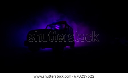 speed lighting of police car in the night on the road. Police cars on road moving with fog. Selective focus