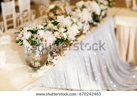 Bouquets flower in vase on the wedding table. Royalty-Free Stock Photo #670242463