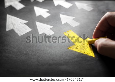 Individuality chalk arrow going a different direction on blackboard Royalty-Free Stock Photo #670243174