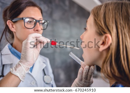 Female pediatrician using a swab to take a sample from a patient's throat Royalty-Free Stock Photo #670245910