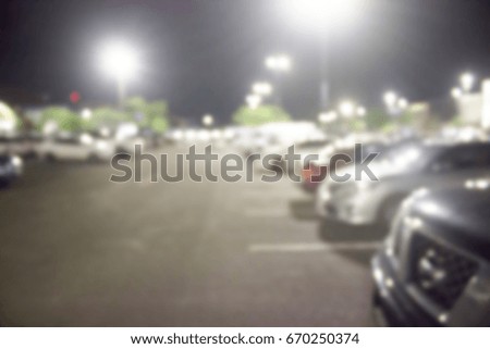 blur cars parking with bokeh light Background for use as Background
