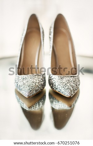 Wedding shoes on a mirror. Royalty-Free Stock Photo #670251076