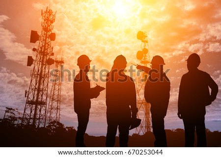 Silhouette Teams engineer looking Telecommunication mast television antennas on sunlight Royalty-Free Stock Photo #670253044