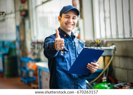 Smiling mechanic thumbs up