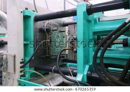 Injection moulding machine used for the forming of plastic parts using plastic resin and polymers Royalty-Free Stock Photo #670265359