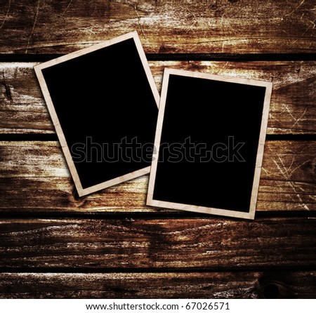 Old blank photos frames lying on a wood surface for text and photo