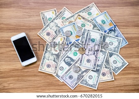 Mobile smart phone and US Dollar banknote coin money cash, Fintech and digital money concept
