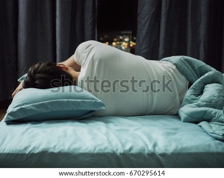 Man sleeping n bed at night Royalty-Free Stock Photo #670295614