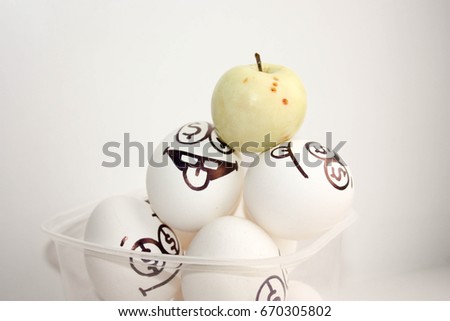 Concept of profit. Apple green and eggs with eyes dollars. Photo for your design