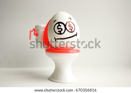 The concept of losing business. An egg with a painted face on the toilet. 