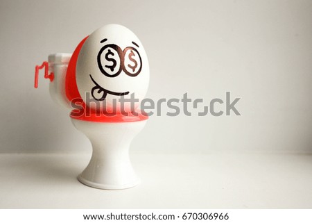 Concept of bankrupt business. An egg with a painted face on the toilet.