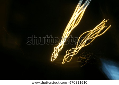 Street lights in speeding car in night time, light motion with slow speed shutter.