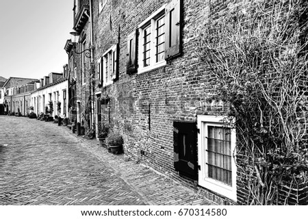 Typical Dutch brick houses in Holland. Street View with bikes parked in the historical center of Amersfoort in the Netherlands. Black and white picture
