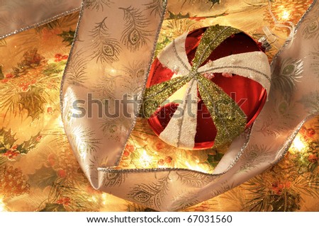 Close up image of Christmas decorations with ornaments, ribbon, and lights