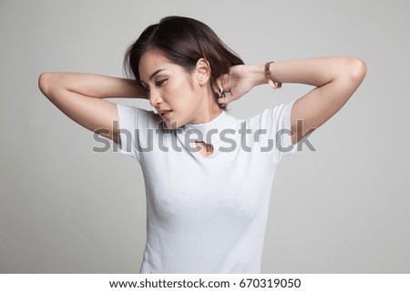 Sleepy young Asian woman yawn on gray background