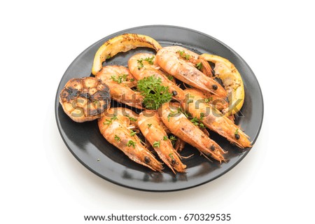 fried shrimps with garlic and lemon isolated on white background