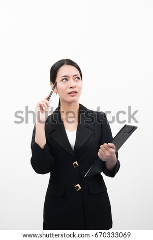 Thoughtful businesswoman looking up and pointing and holding document isolated over a white background