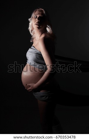 Pregnant Woman with scarf on Black Background