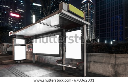 Blank billboard at bus stop at night in city of China.