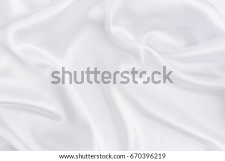 Closeup of white smoot fabric as a background. Royalty-Free Stock Photo #670396219