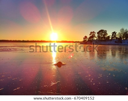 Panorama of Sweden in winter with the icy sea at sunset