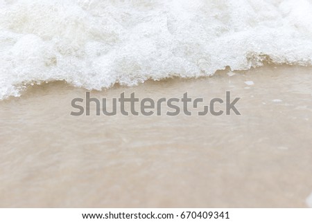 Close up bubbles of waves on the beach