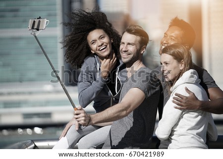 Group of friends taking selfie picture, Manhattan in background