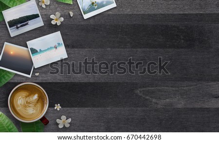 Credit card payment for travel, food and drink. Top view Credit card, Seascape photos,Airplane, Smartphone,Coffee cup , Sneakers and Plumeria flower on blue wooden table. Commerce and travel concept.