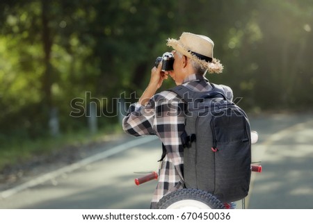 Man traveler are photographer sitting on motorcycle classic photo shooting in tourist is a lifestyle of hipster senior 