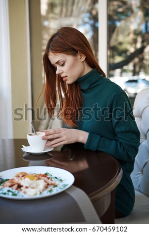 Woman in a cafe, mug, pizza                               