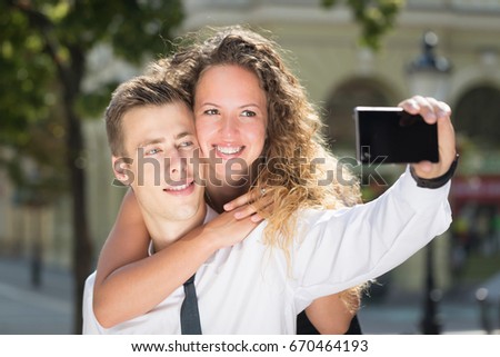 young couple selfy on street