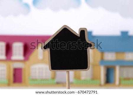 house shape blackboard in front of the model house as background