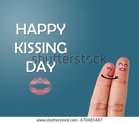 Happy kissing day with Painted finger kiss on blue background.