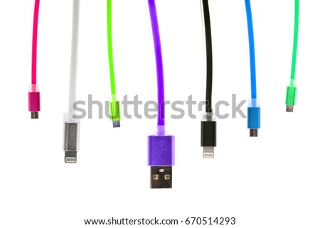 Eight multicolored usb cables, with connectors for micro and other, hang vertically, on a white isolated background. The family unites. future technologies.