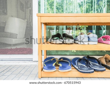 close up wooden shoes rack at the house door