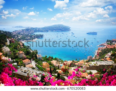 lanscape of riviera coast, turquiose water, flowers and blue sky of cote dAzur at summer day, France, retro toned Royalty-Free Stock Photo #670520083