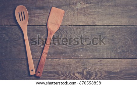 Wooden spoon for cooking on the table.