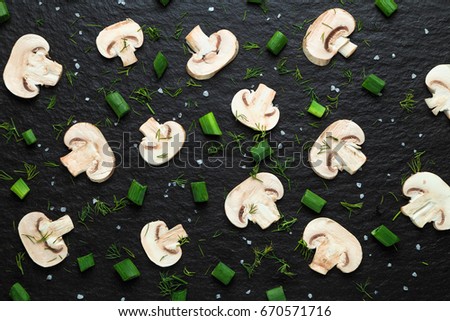 pattern from pieces of vegetables laid out on a black basalt surface
