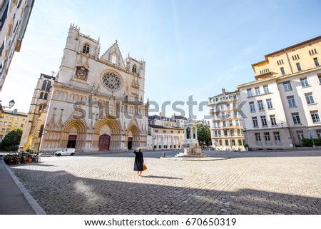 Morning view on the saint John cathedral with woman walking on the square in the old town of Lyon city Royalty-Free Stock Photo #670650319
