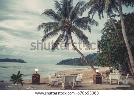 Tropical island coast sea landscape with the blue sunny sky. Sunset. Marble caffe chairs. Vacation holiday concept. Travel inspiration. Copy space.