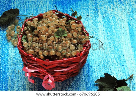 white currants in a jar on wooden background