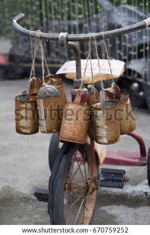 Old bicycle for kids hanging on canvas rope rusty vintage style.